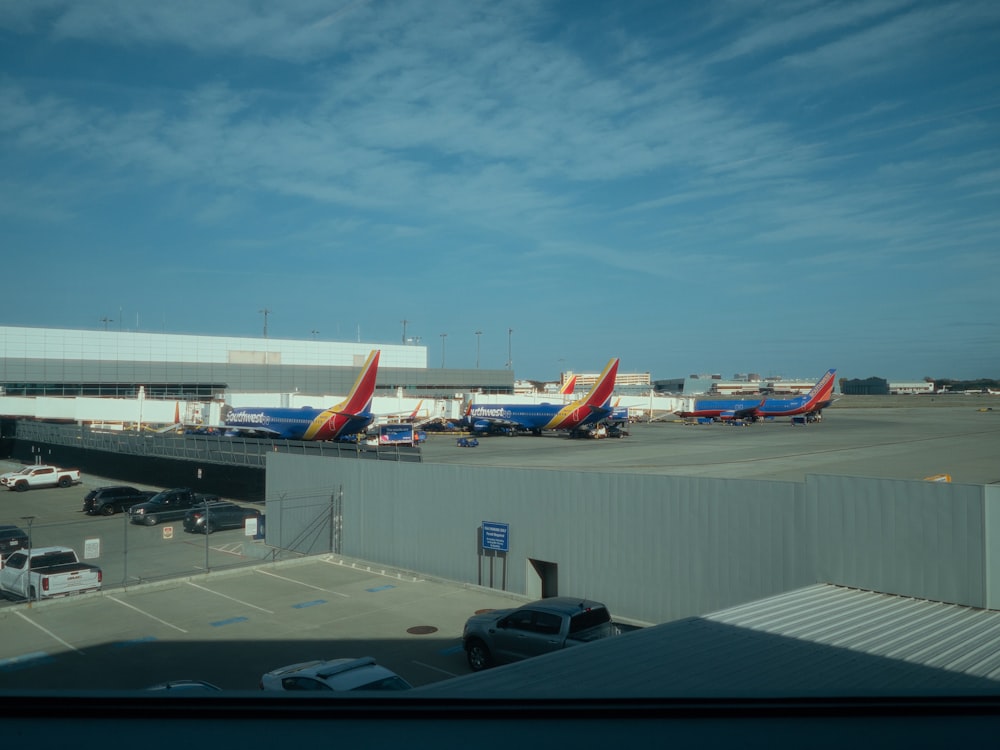 a group of airplanes parked at an airport