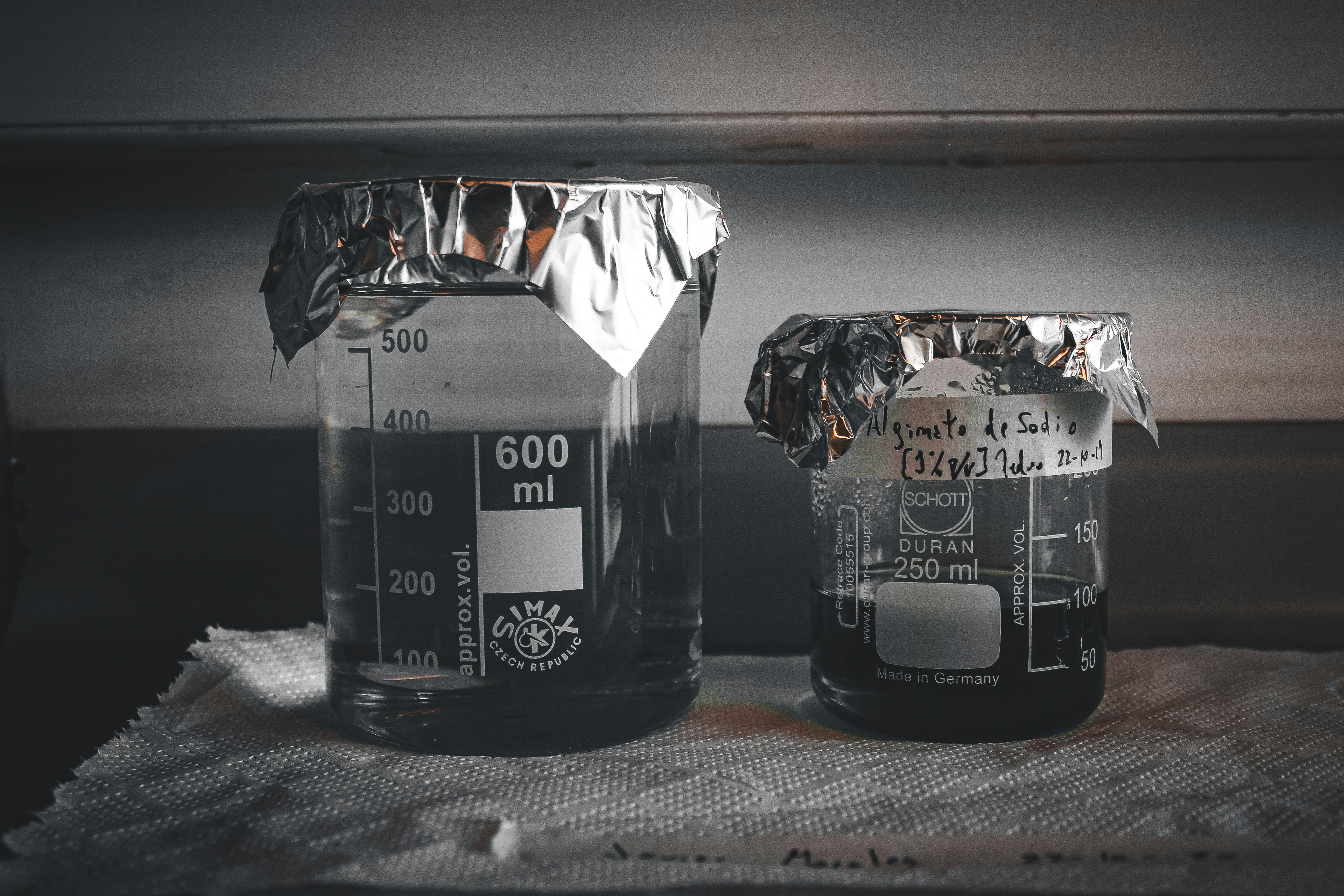 a couple of jars filled with liquid sitting on top of a table