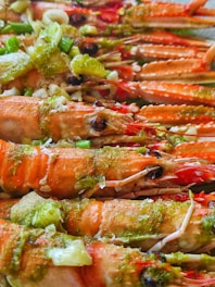 a close up of a plate of food with lobsters and broccoli
