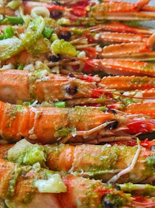 a close up of a plate of food with lobsters and broccoli