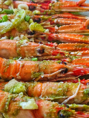 a close up of a plate of food with lobsters and broccoli