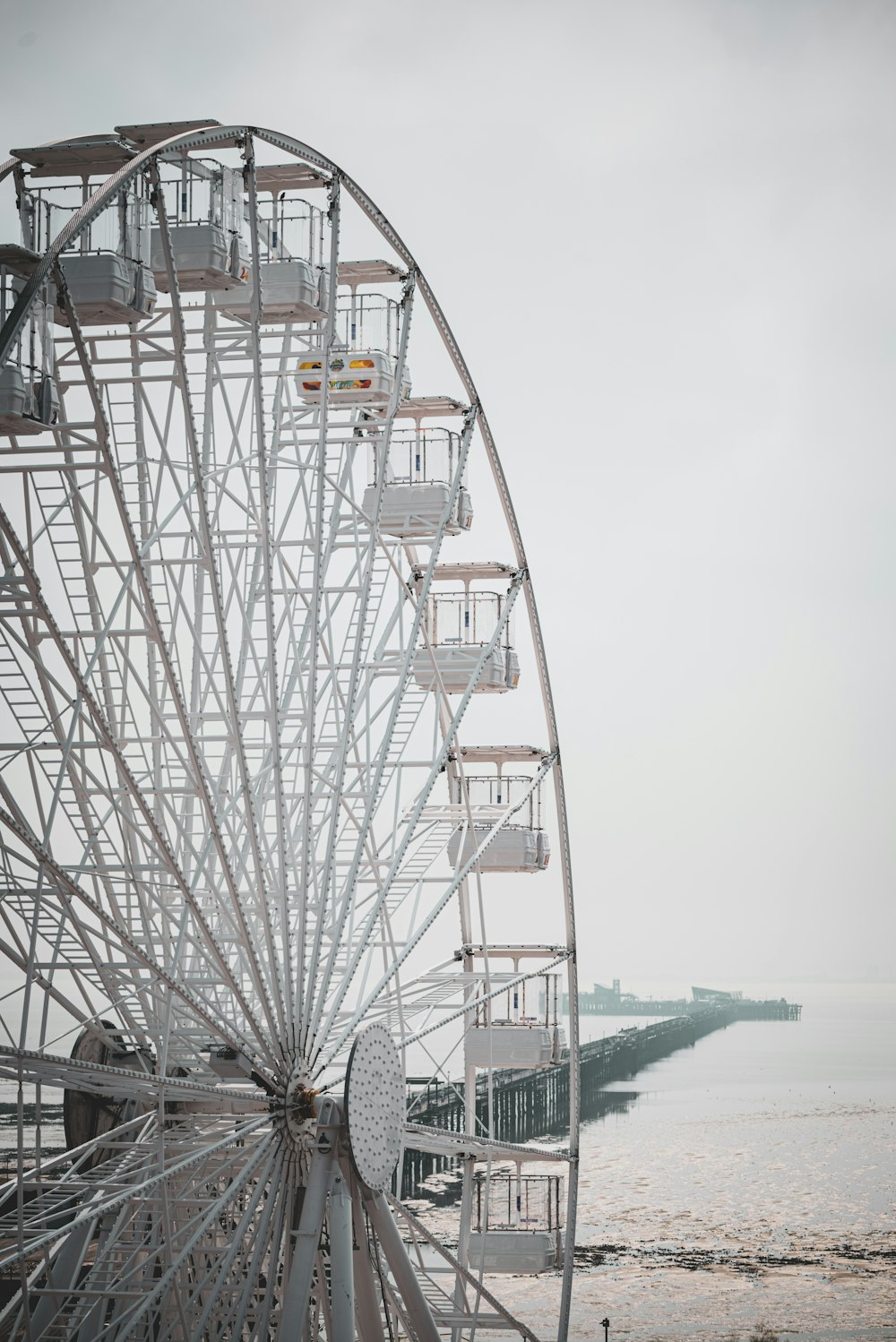 a large ferris wheel sitting next to a body of water