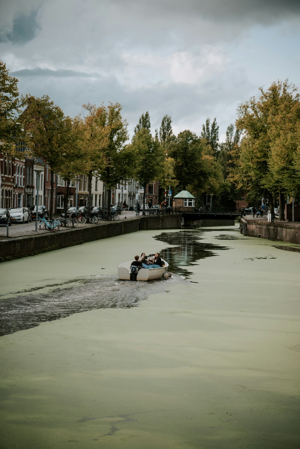 Ein Boot, das neben hohen Gebäuden einen Fluss hinunterfährt