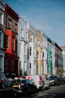 a row of multi - colored buildings on a city street