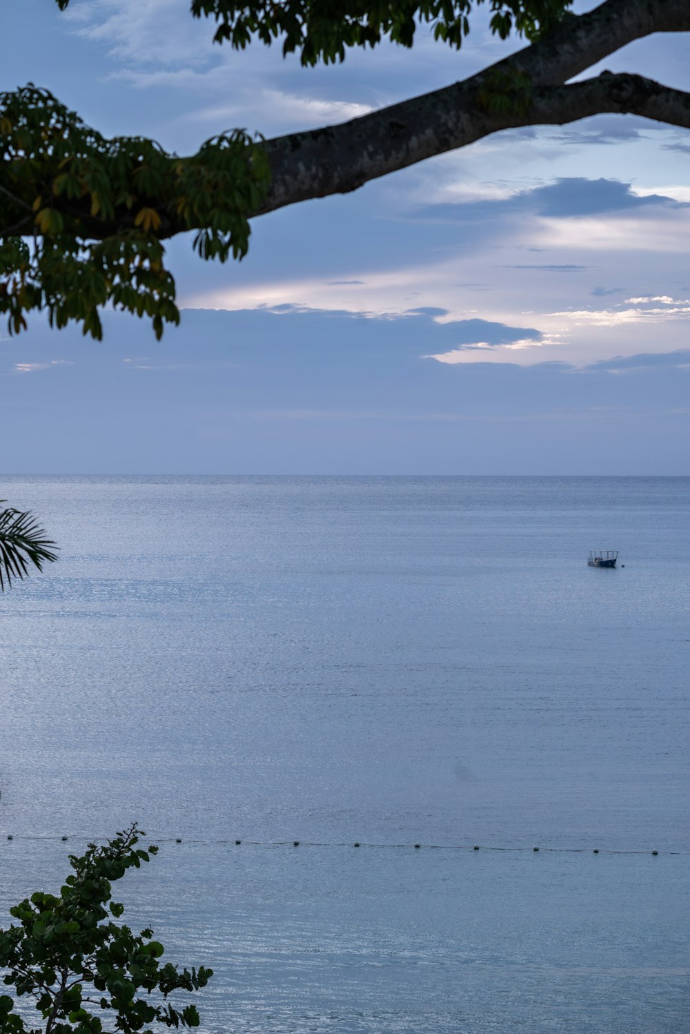 a boat is out on the water at dusk