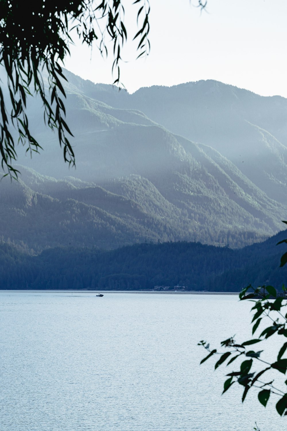 a body of water with mountains in the background