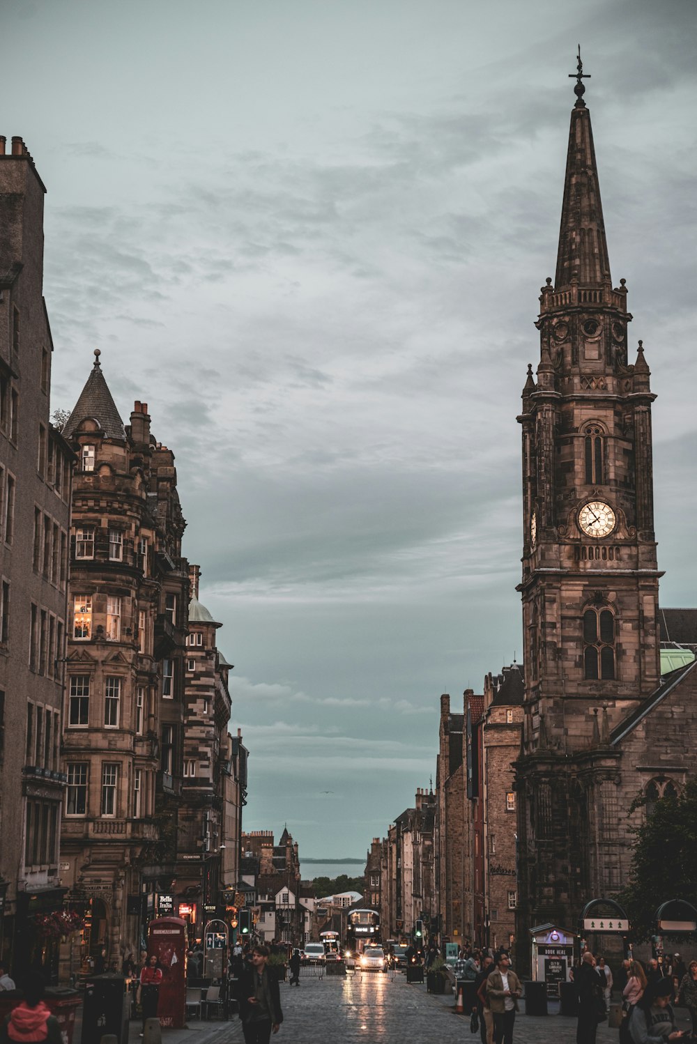 a clock tower towering over a city street