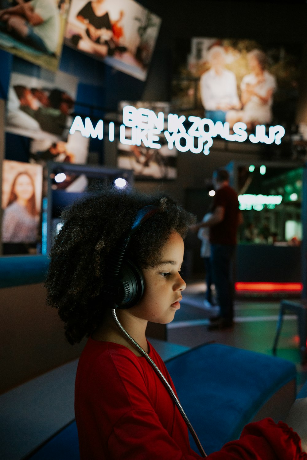 a young girl wearing headphones and listening to music