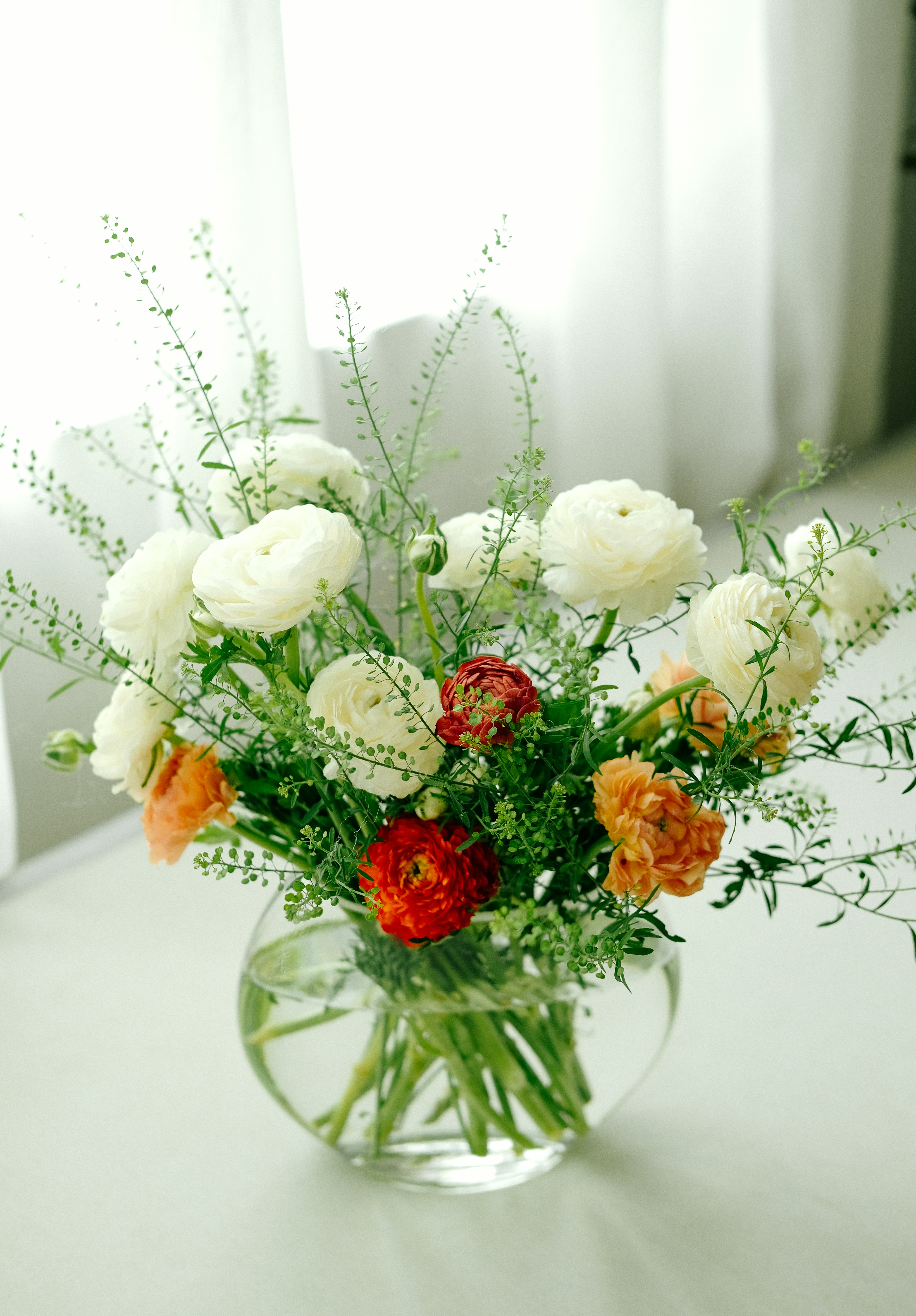 a vase filled with lots of white and orange flowers