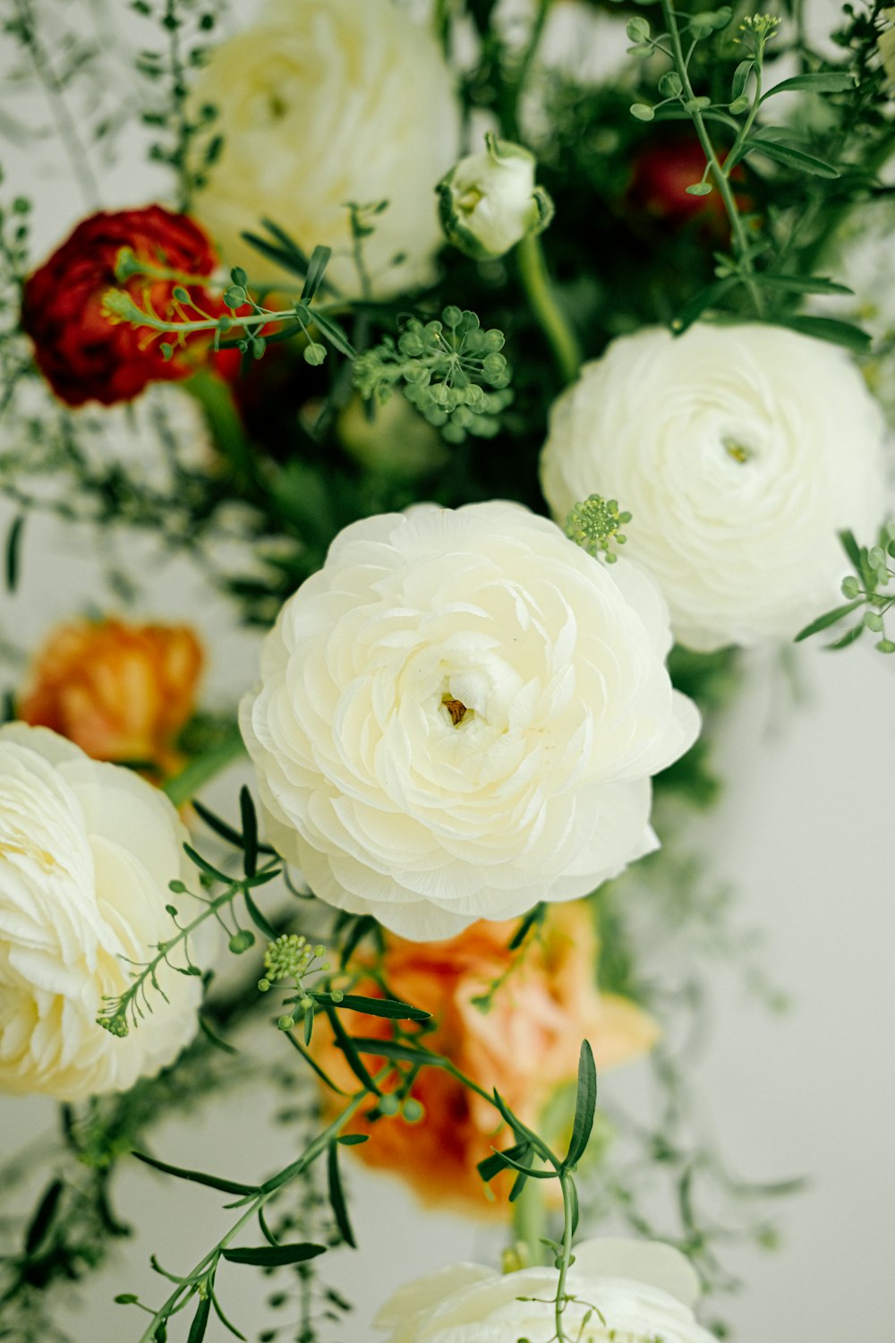 a bouquet of white and red flowers on a table