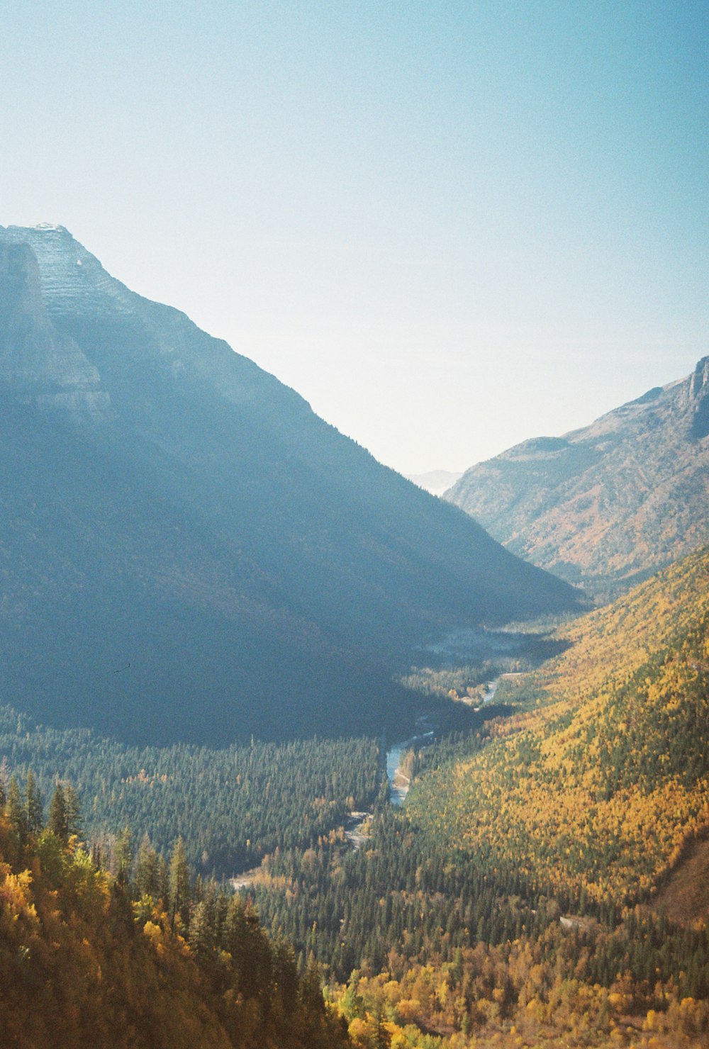 a view of a valley with a river running through it