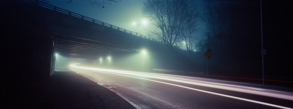 a foggy night on a highway with street lights