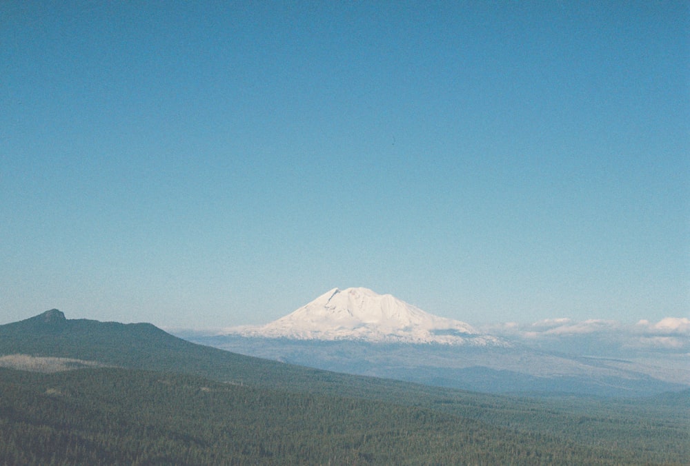 a view of a snow covered mountain in the distance