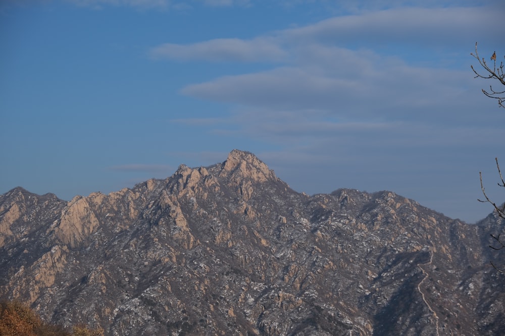 a view of a mountain range from the top of a hill