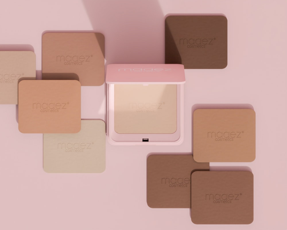 a group of different shades of powder on a pink surface