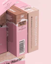 two boxes of pink chocolate are stacked on top of each other