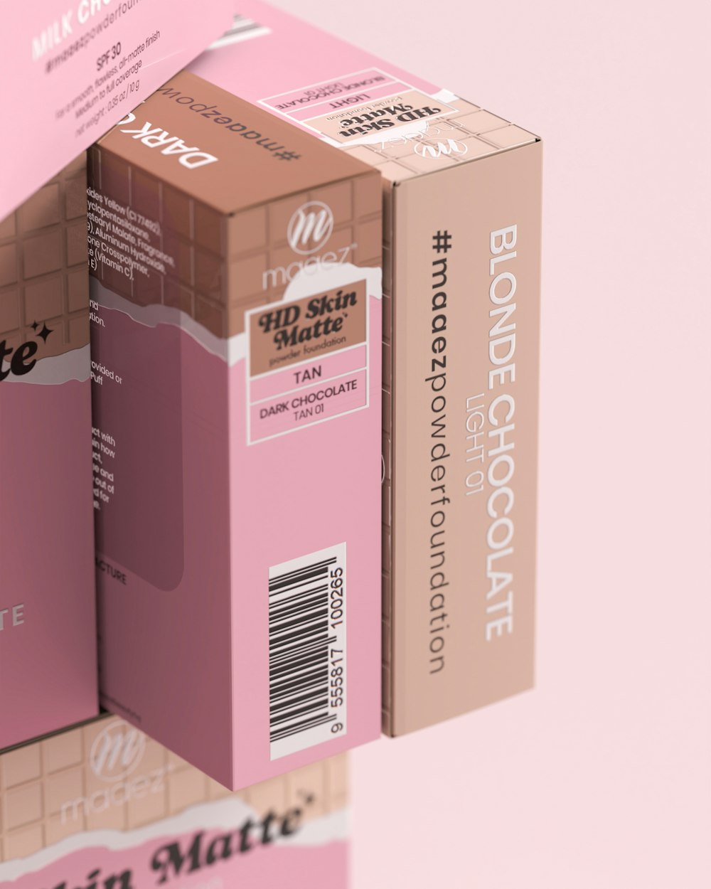 two boxes of pink chocolate are stacked on top of each other