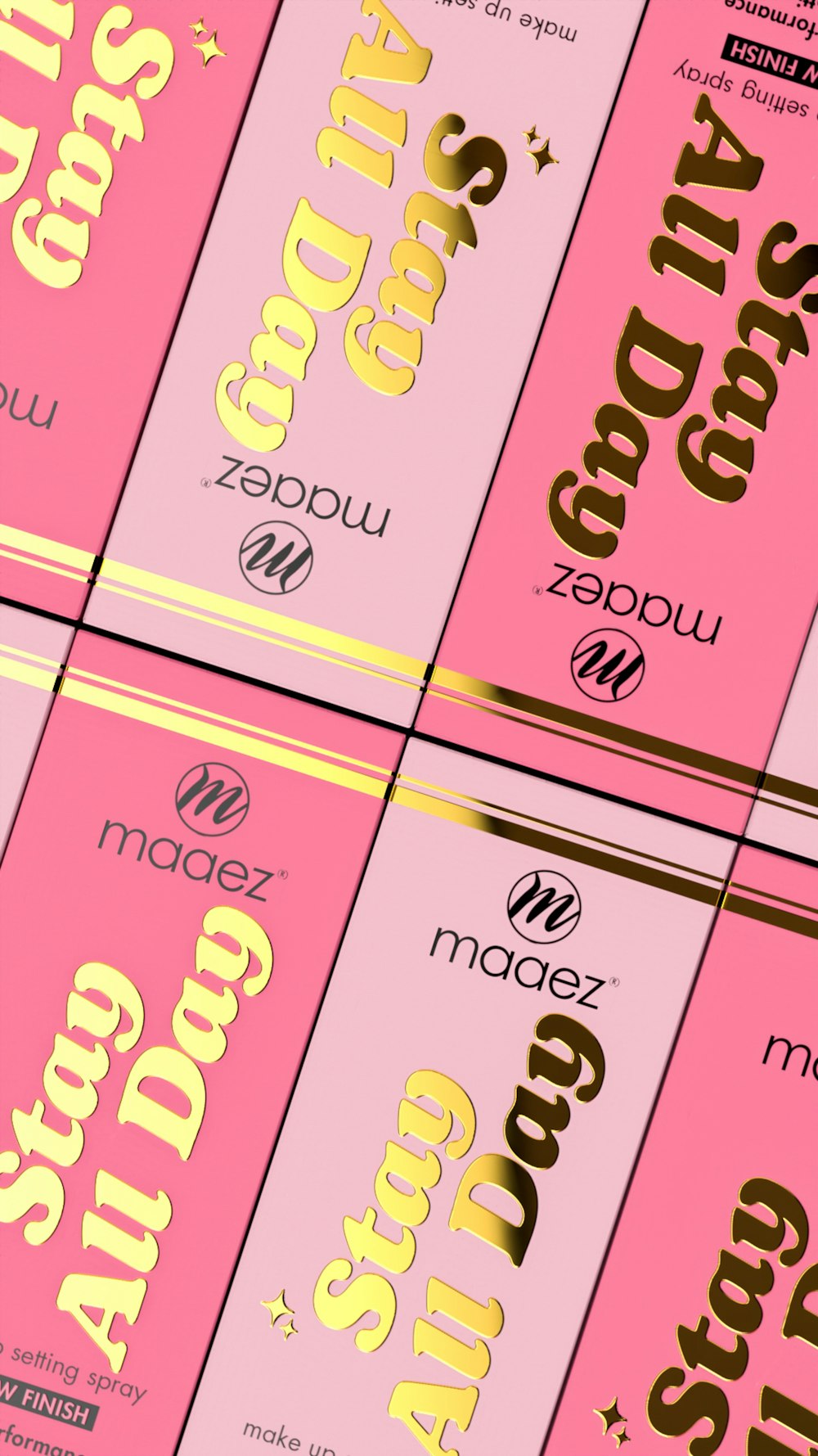 a group of pink and gold cigarettes sitting on top of each other