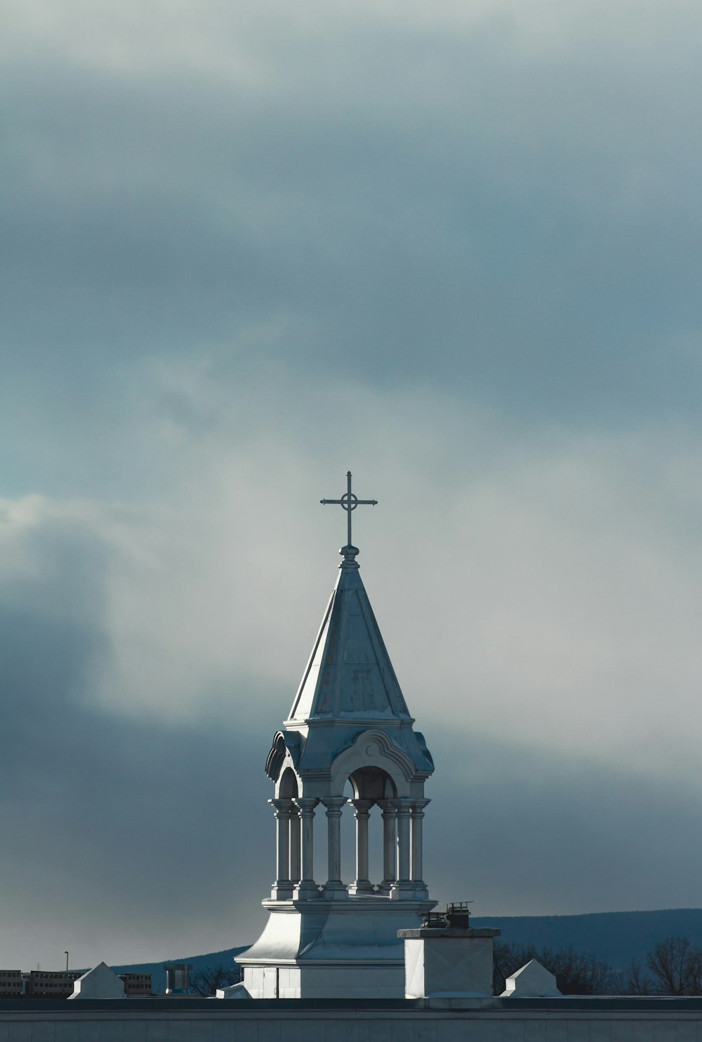 a church steeple with a cross on top