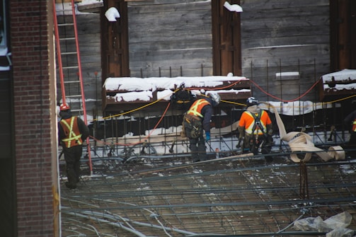 a group of construction workers working on a building