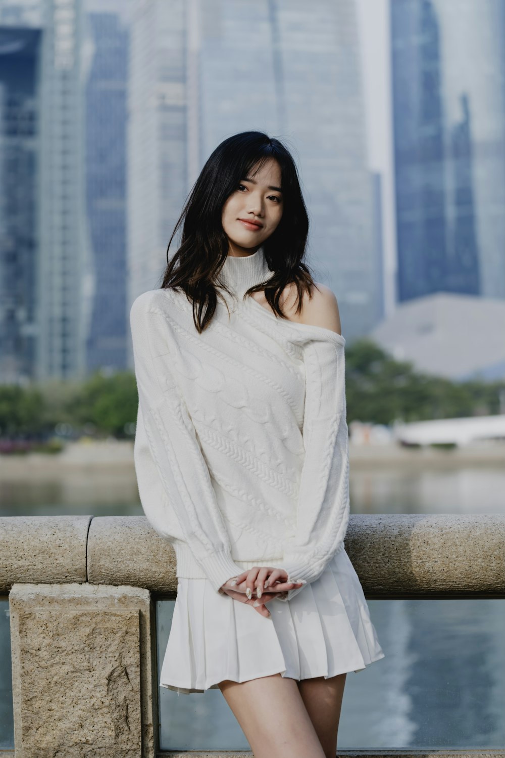 a woman in a white dress posing for a picture