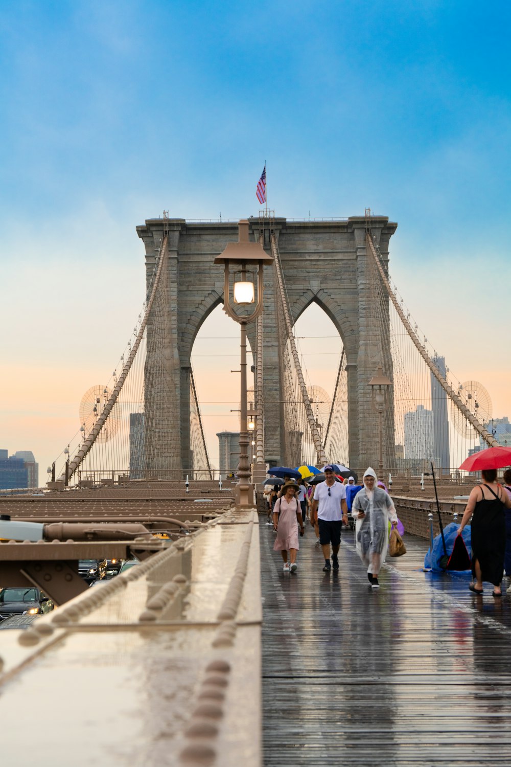 a group of people walking across a bridge