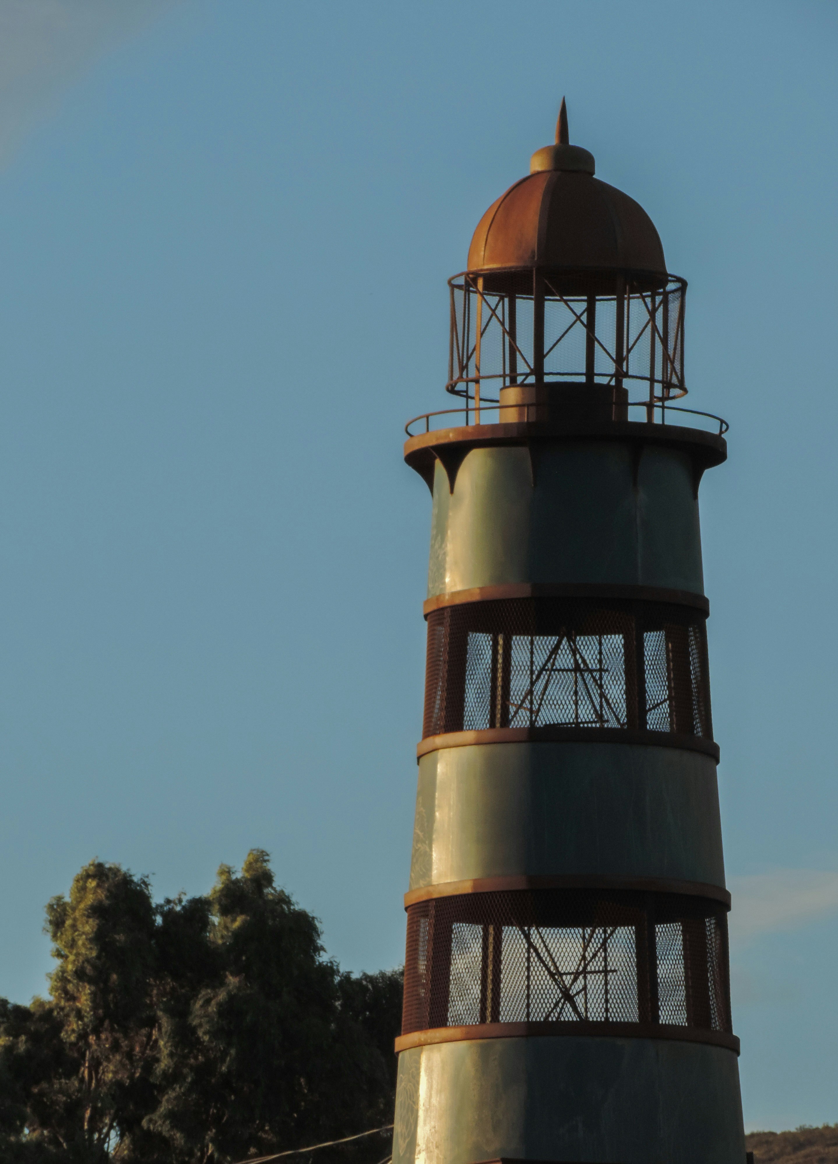 A large light house sitting on top of a hill photo – Free Monastery ...