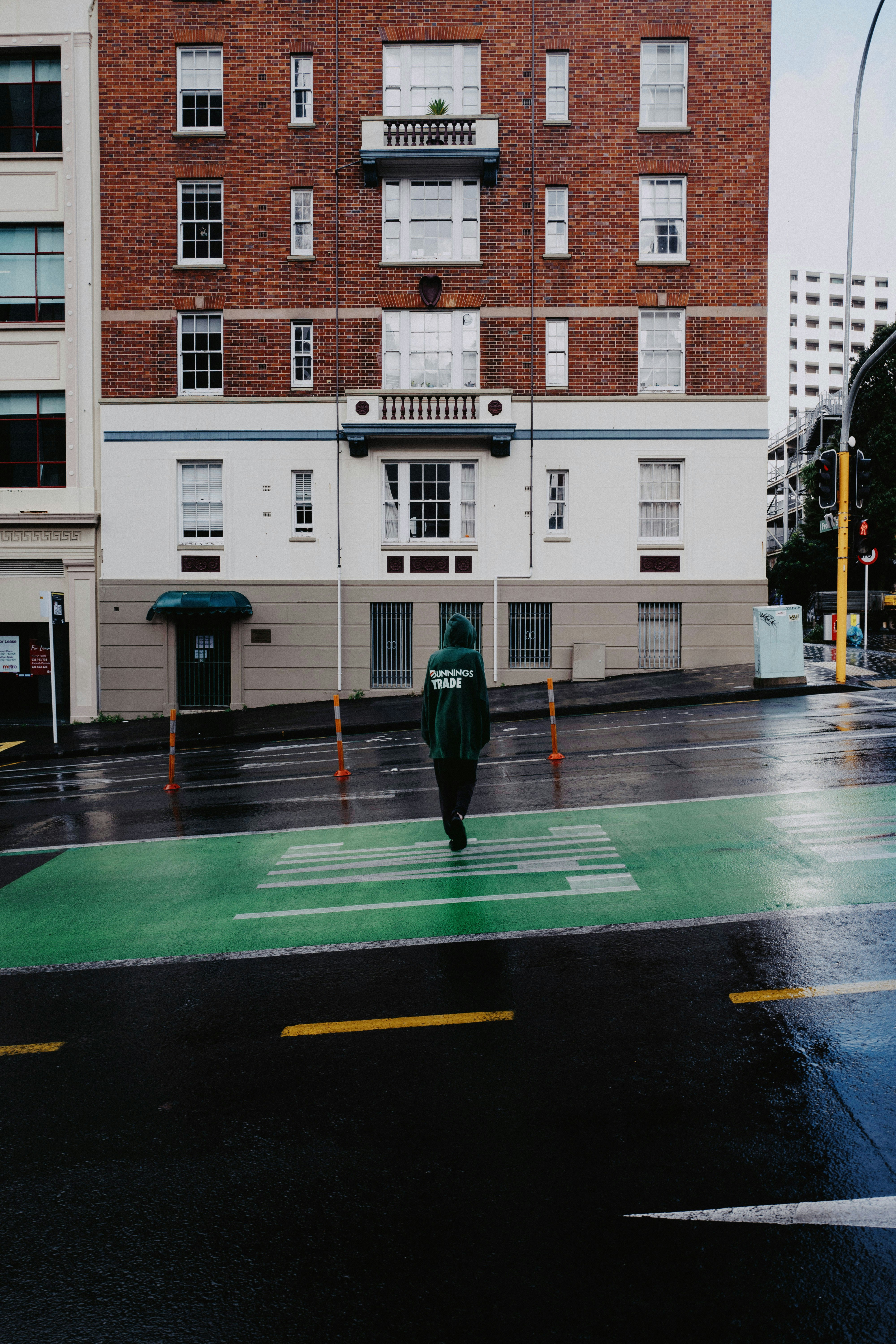 a green fire hydrant sitting on the side of a road