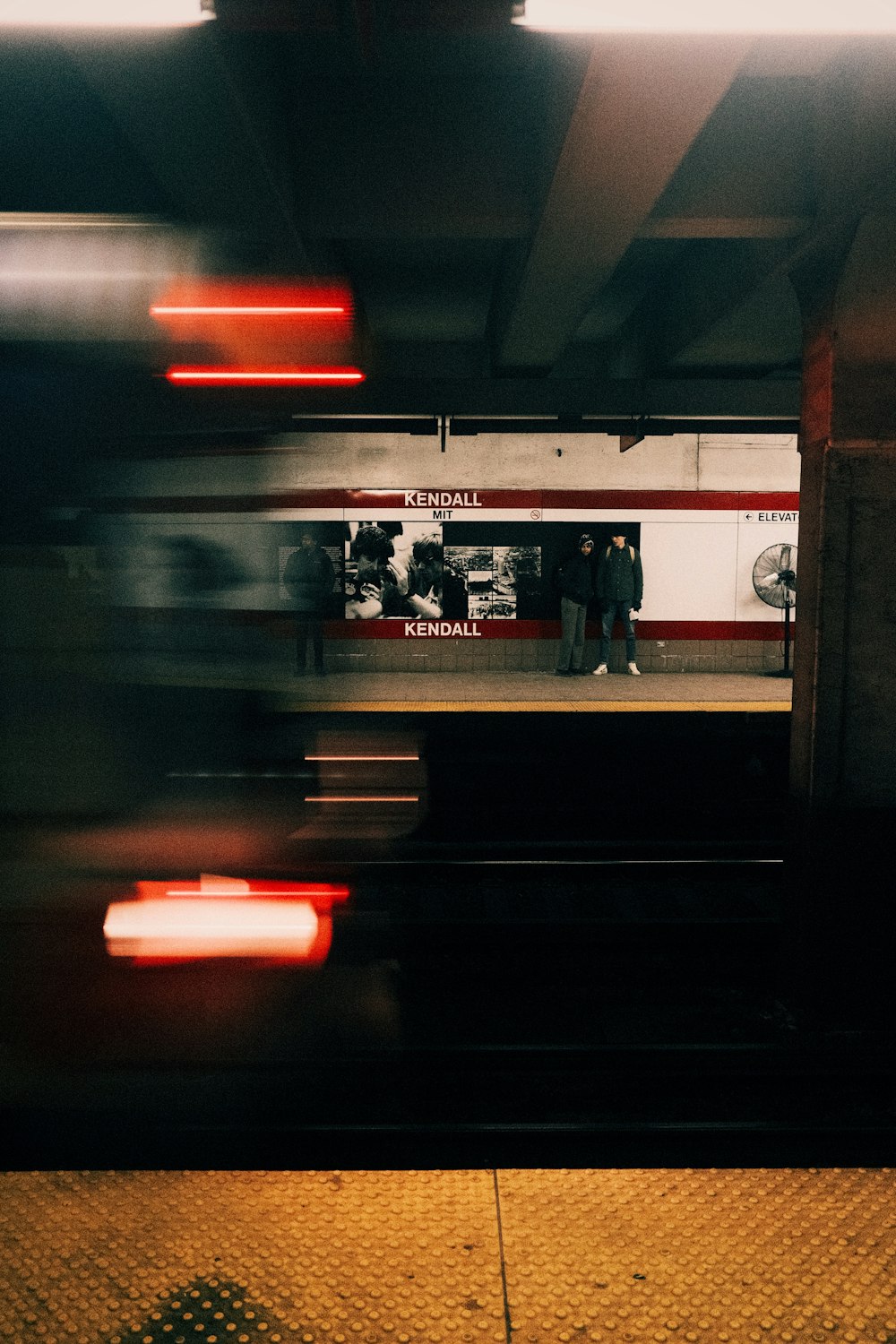 a subway station with people waiting for the train