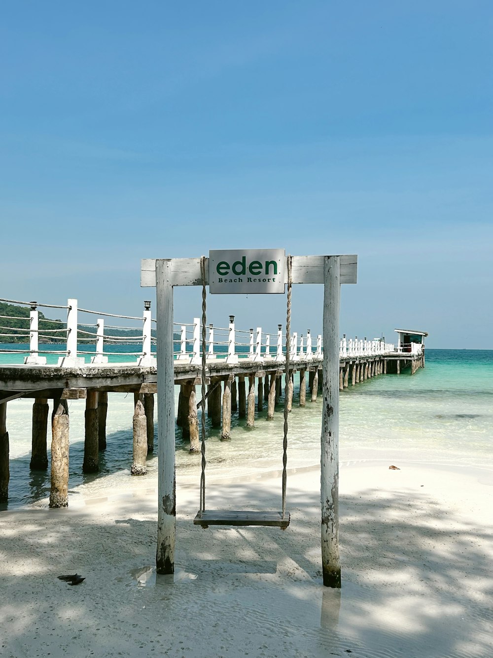 a wooden pier with a sign that says eden on it
