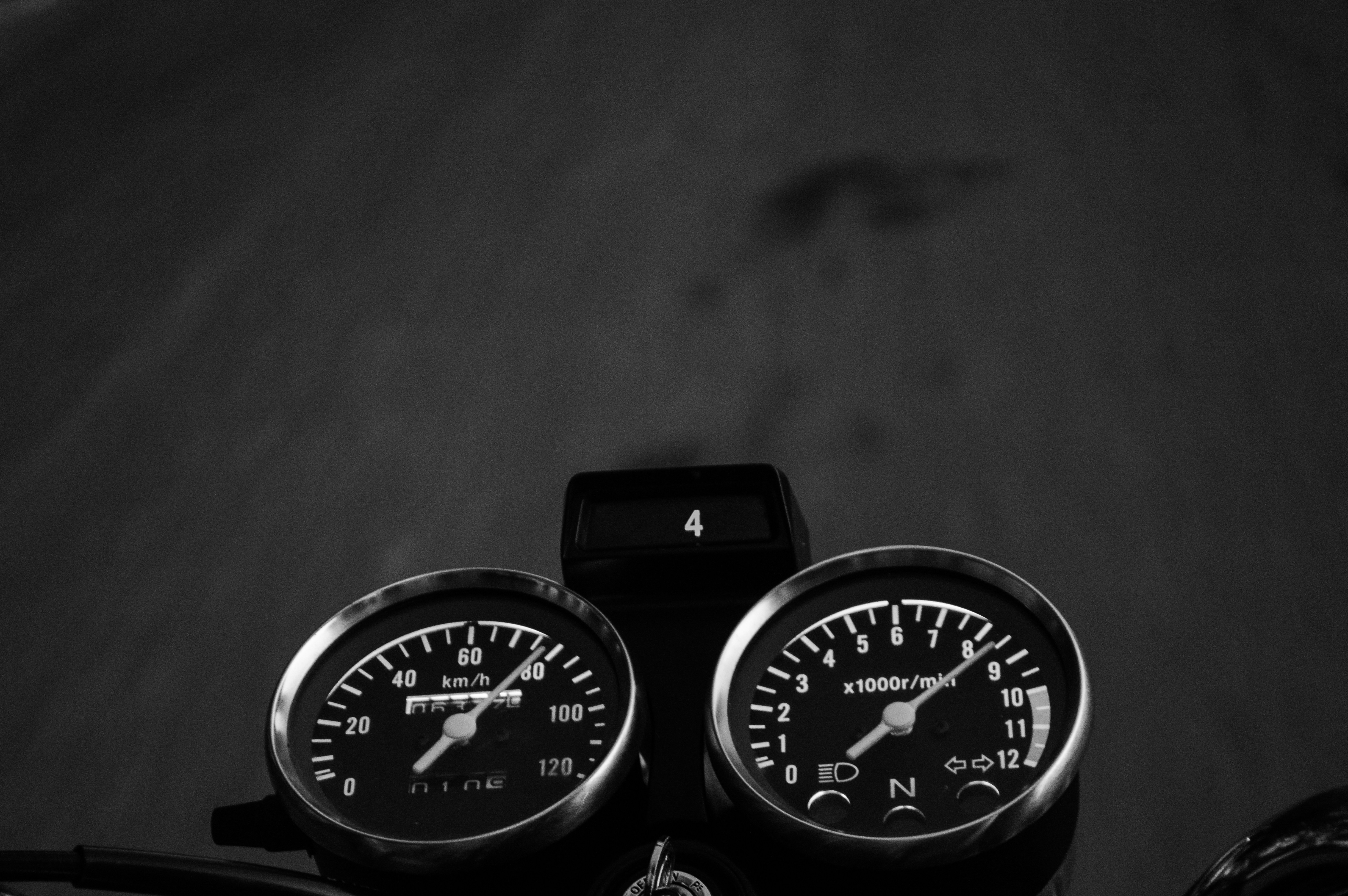 A black and white photo of a motorcycle speedometer photo Free