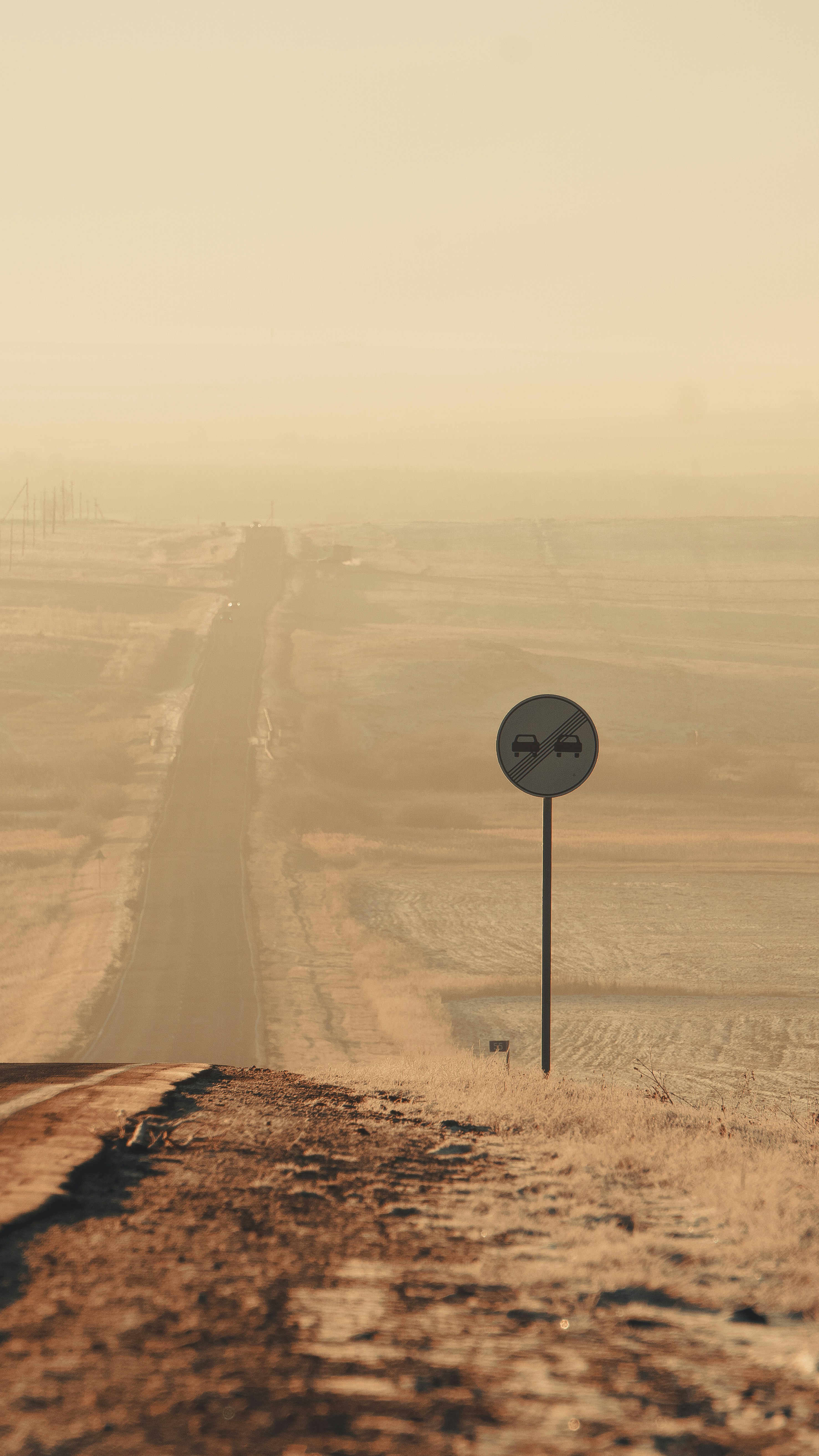 Road sign marks a desolate road ahead.