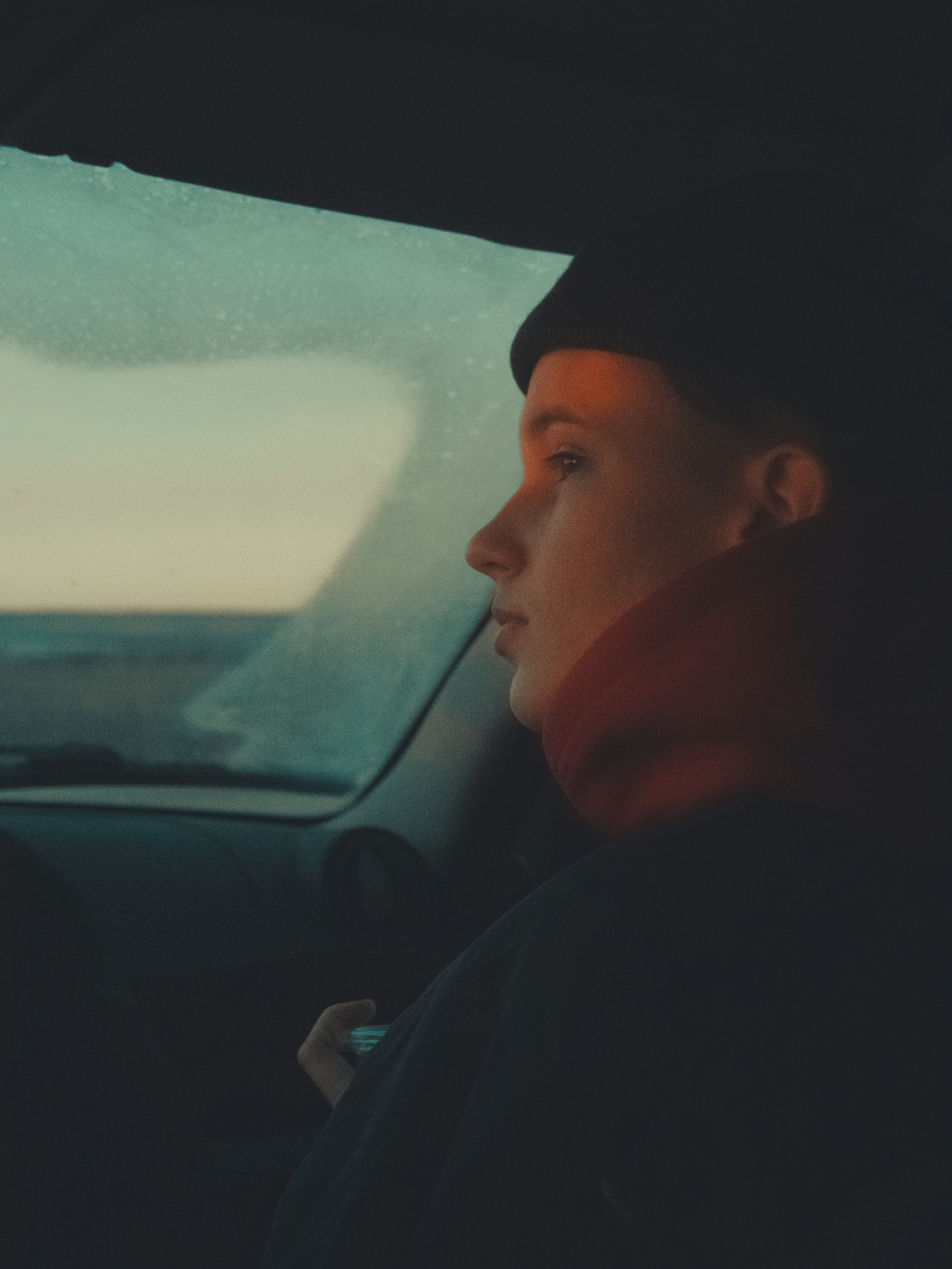 Person looks out of a car window.