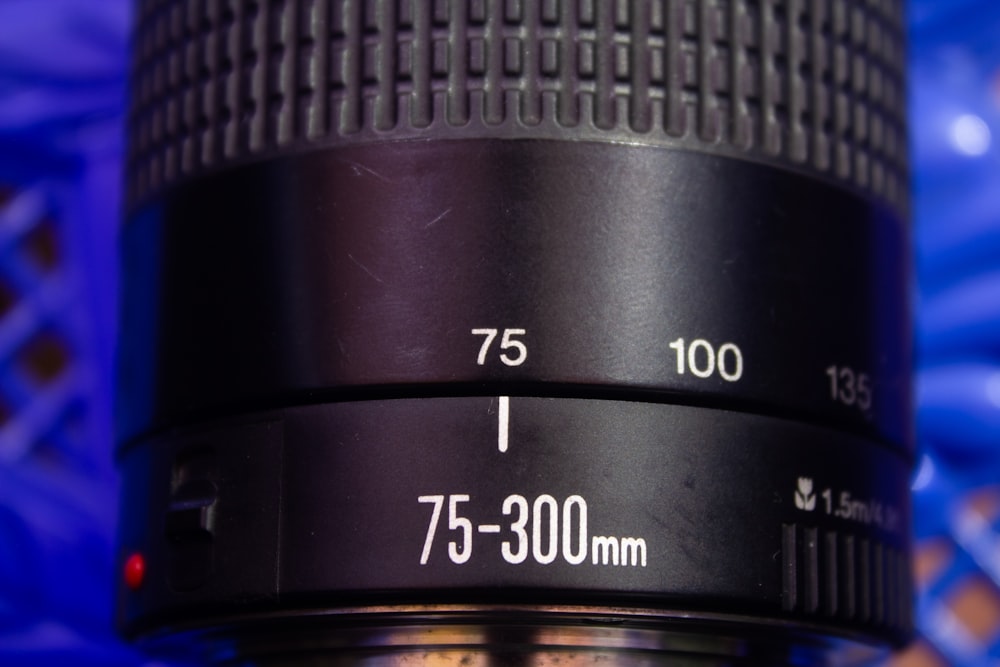 a close up of a camera lens on a blue background