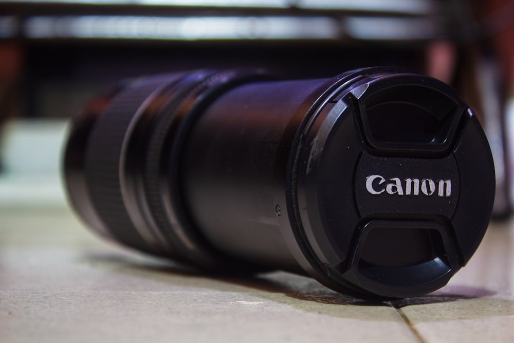 a camera lens sitting on the ground next to a table