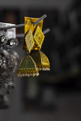 a pair of earrings hanging from a hook