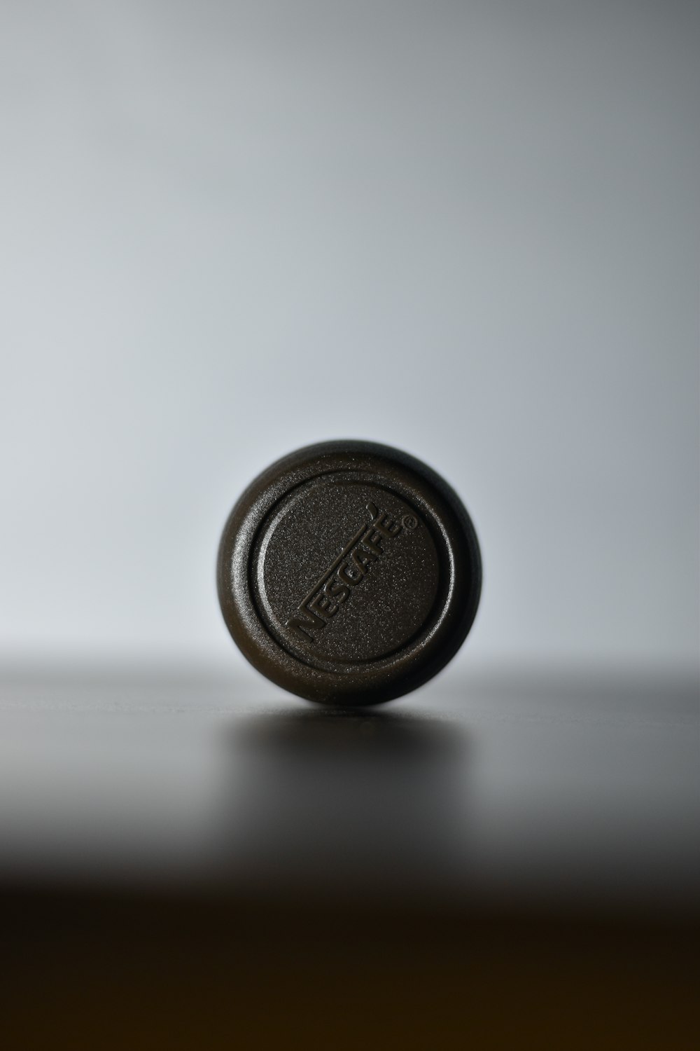 a close up of a bottle cap on a table