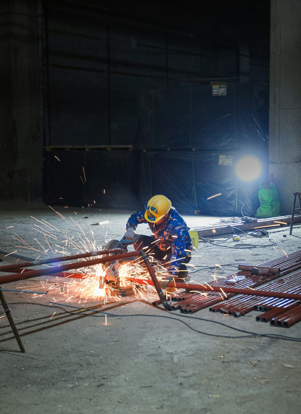 a man in a hard hat working on a piece of metal