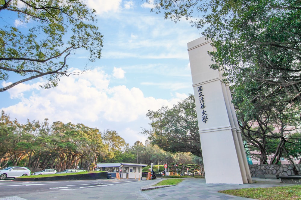 a tall white tower sitting next to a parking lot