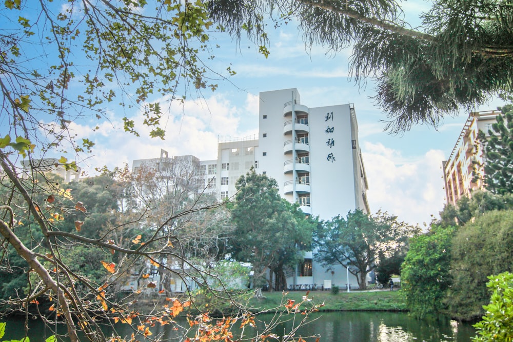 a large white building sitting on top of a lush green park