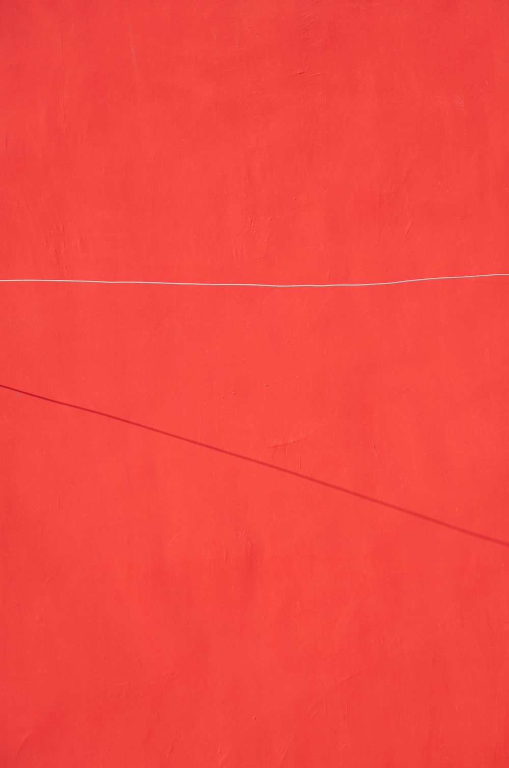 a red wall with a white line on it