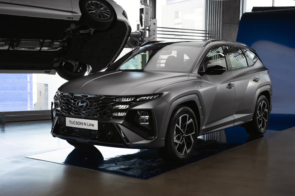 a grey suv is on display in a showroom