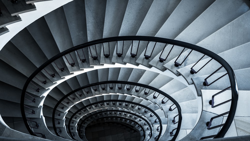 a spiral staircase in a building with a black and white photo