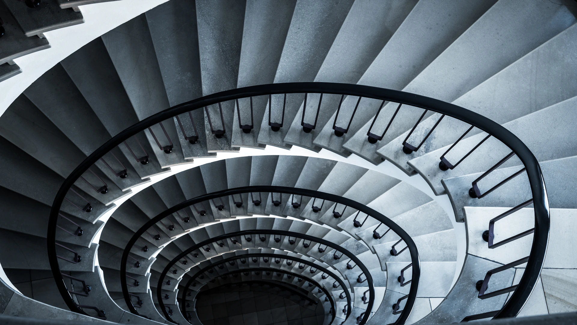 a spiral staircase in a building with a black and white photo