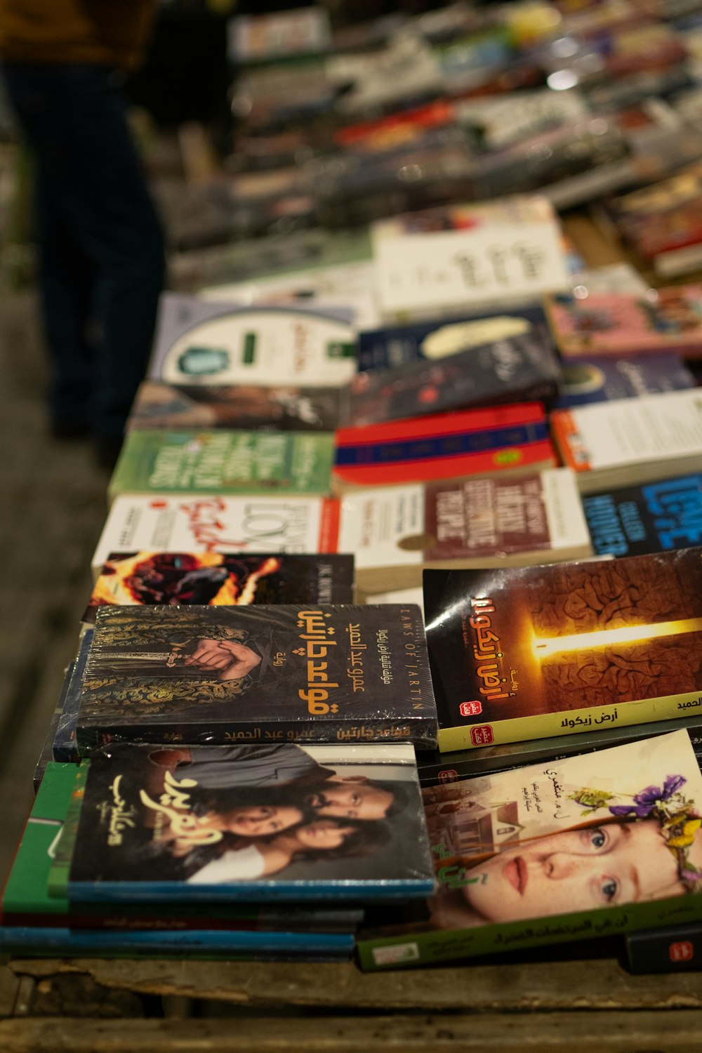 a row of books sitting on top of a wooden table