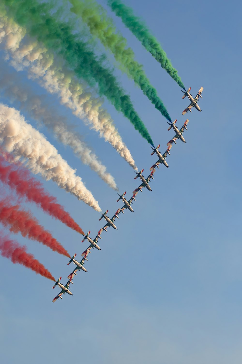 a group of planes flying in formation in the sky