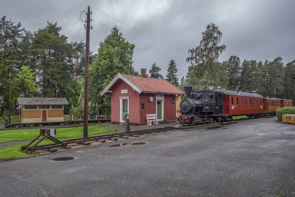 a small train station with a train on the tracks