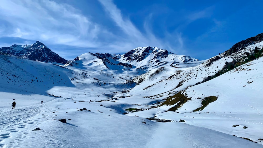 a person hiking up a snow covered mountain