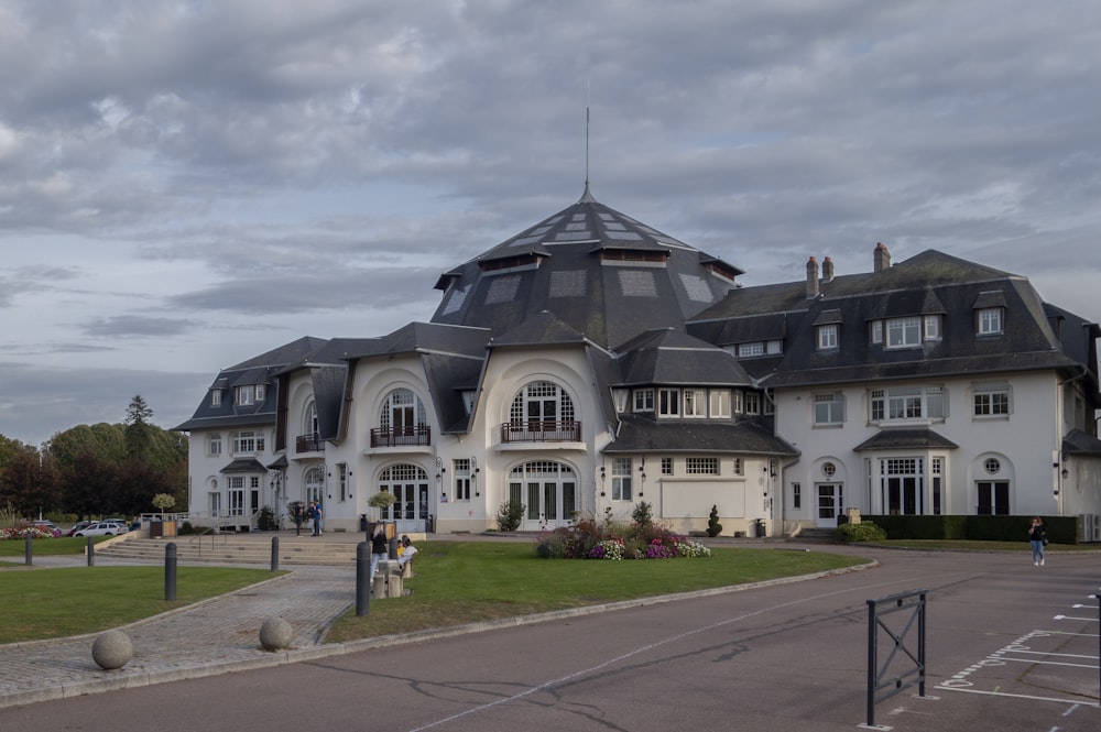 a large white building with a black roof