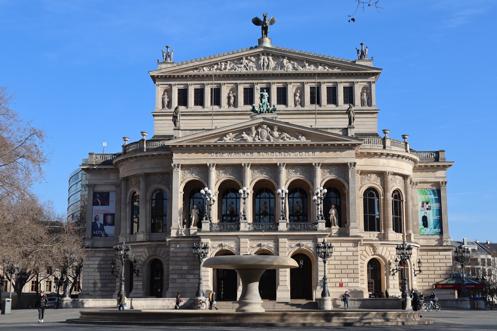 a large building with a fountain in front of it